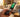 Hand holding a modern flip phone displaying a VoLTE HD Voice call indicator on the screen