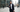 Orthodox Jewish businessman using kosher phone outside office building