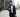 Orthodox Jewish businessman using kosher phone outside office building