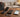Three simple kosher flip phones on a wooden table with Black Friday deal tags and autumn leaves