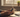 close-up of hands holding a dumbphone, accompanied by a steaming cup of coffee and an open notepad, as part of digital detox timeline.