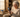 Elderly woman smiling while using a simple easy to use cell phone at her kitchen table