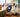 Hand holding a compact travel phone in a sunlit airport terminal, ready for 2026 international travel