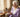 Elderly woman using a simple flip phone for elderly adults at her kitchen table